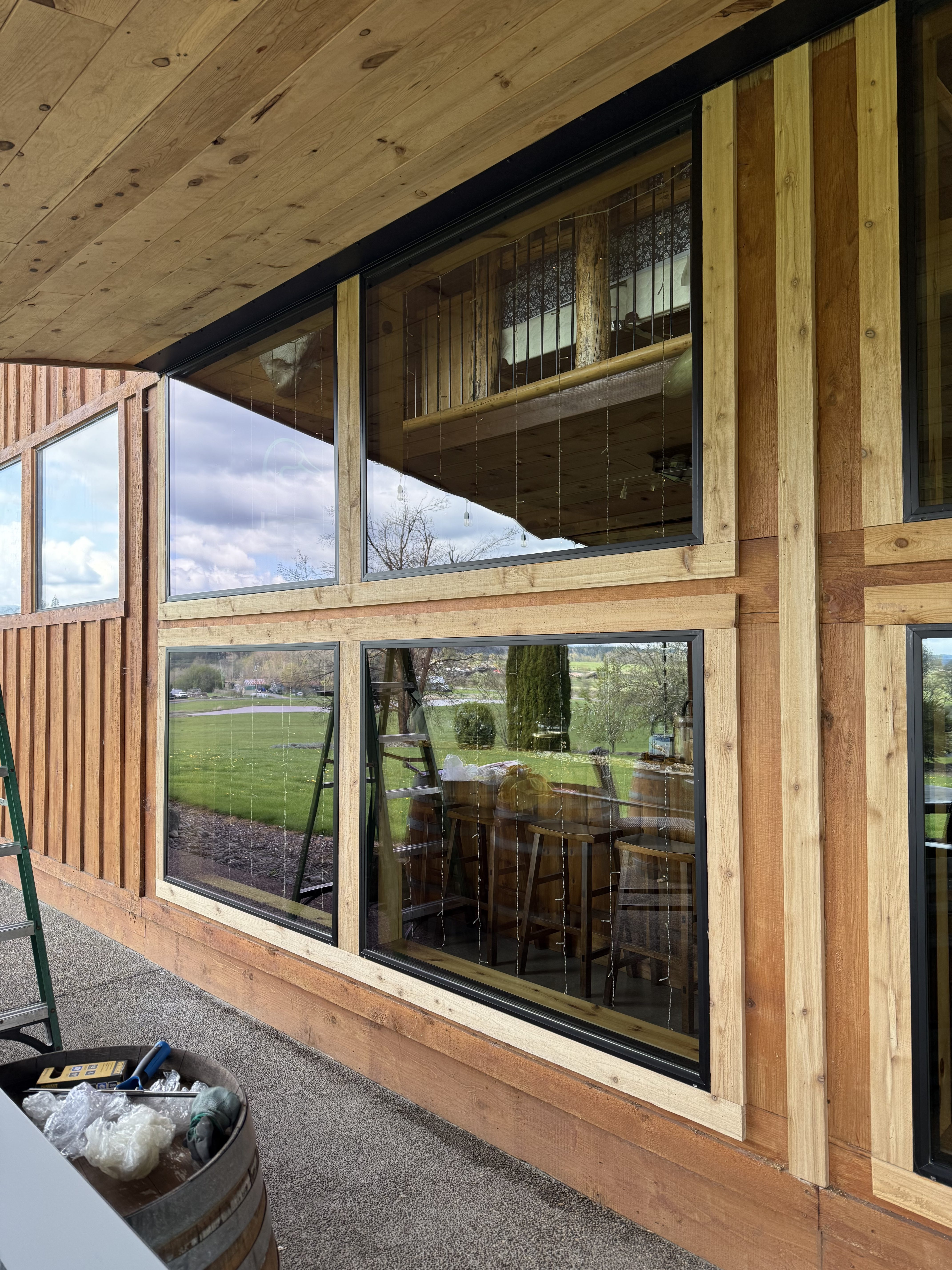 IMG_0273 Covered deck with large windows on the side of a house